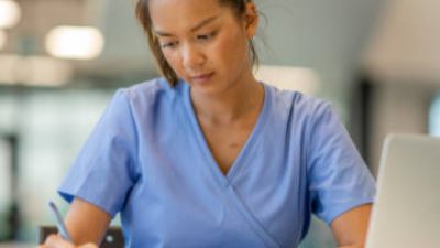 Nurse writing down notes.