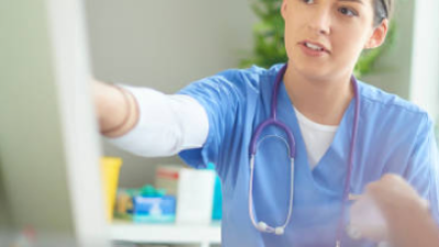 Nurse pointing to screen.