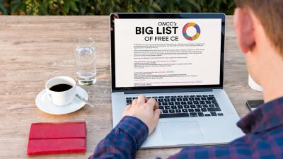 Person accessing Big List of Free CE on laptop