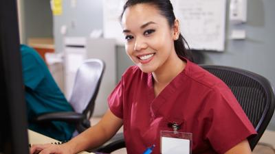 female nurse sitting at computer