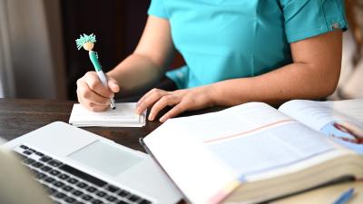Nurse writing notes studying