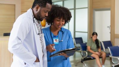 Nurse and doctor reviewing clipboard