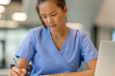 Nurse writing down notes.