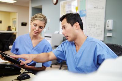 Two nurse colleagues looking at computer