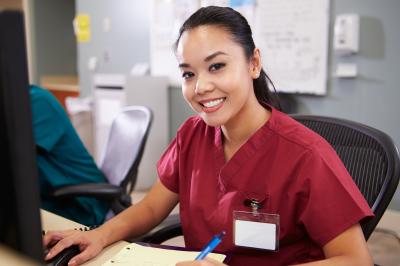 female nurse sitting at computer
