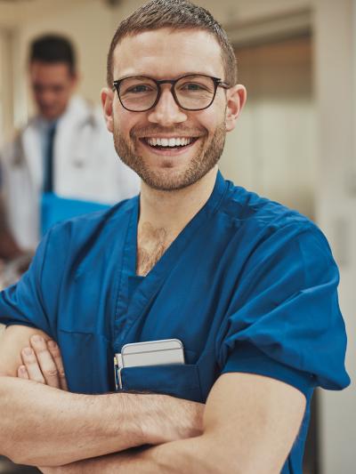 Male nurse smiling with glasses