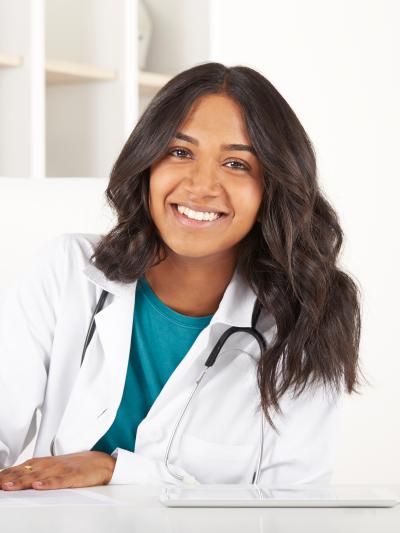 Nurse sitting at desk and writing