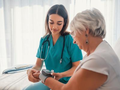 Nurse assisting patient with a device