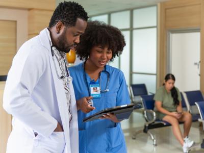 Nurse and doctor reviewing clipboard